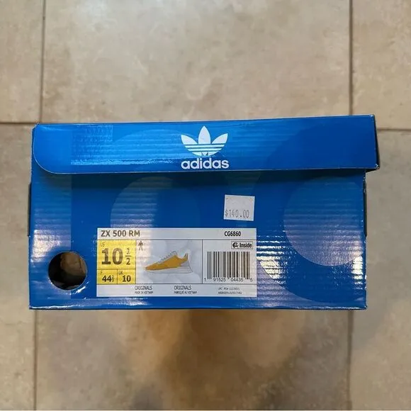 Men’s Adidas ZX 500 RM shoes in yellow.