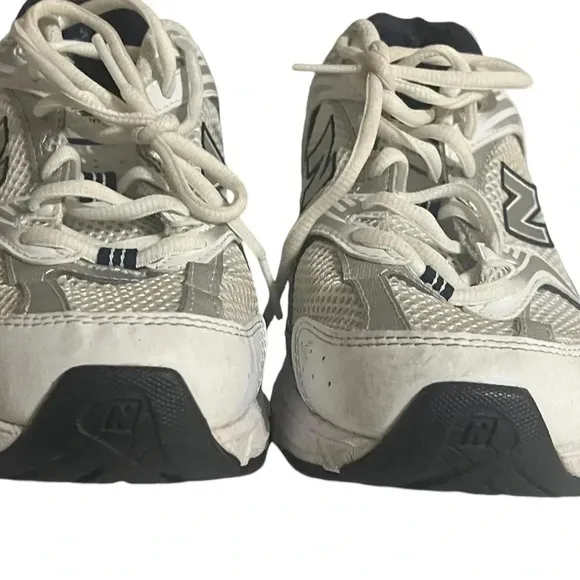 Size 7.5 Men’s New Balance color White silver sneaker WL574G02. Shoes